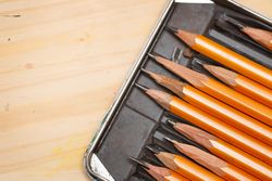 Looking down at box of graphite pencils for artist