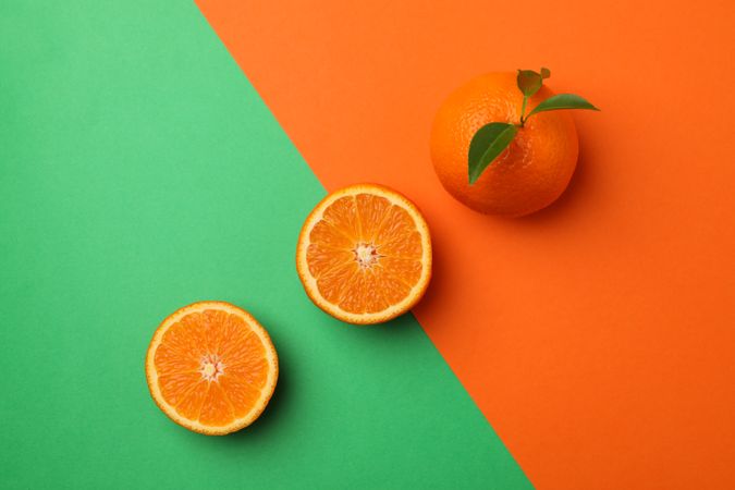 Ripe mandarins on two tone background, top view