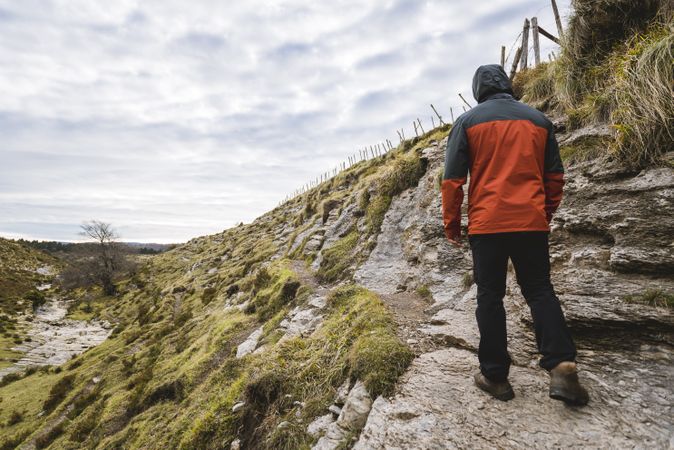 Man walking on hill near valley