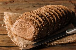 Freshly baked rye bread on napkin on table
