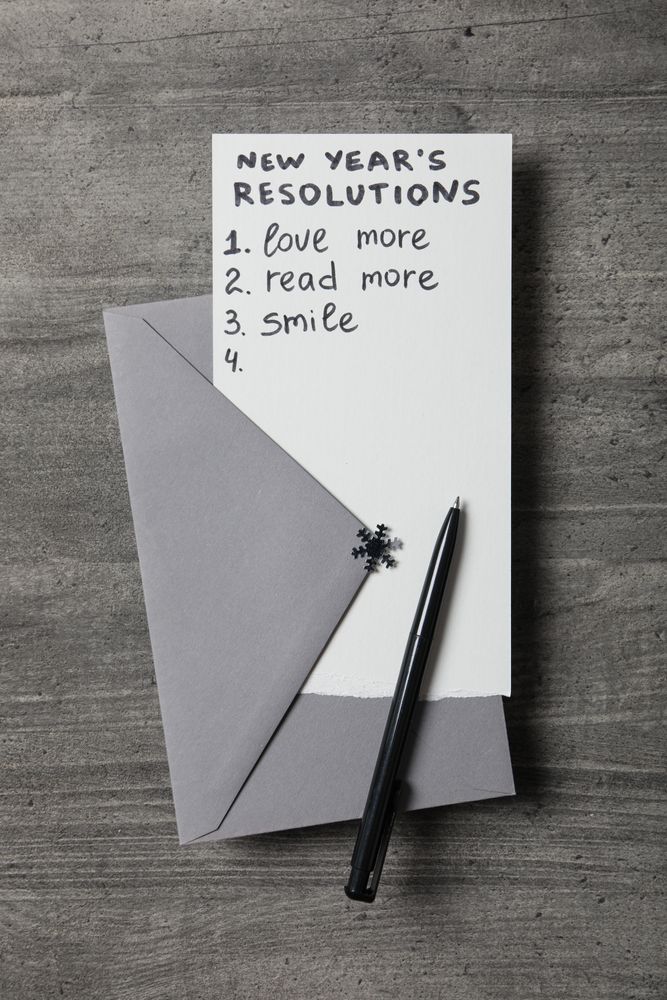 Envelope, pen and paper with list on gray wooden background, top view