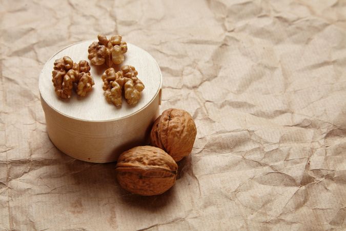 Open and shelled walnuts with wooden cheese box