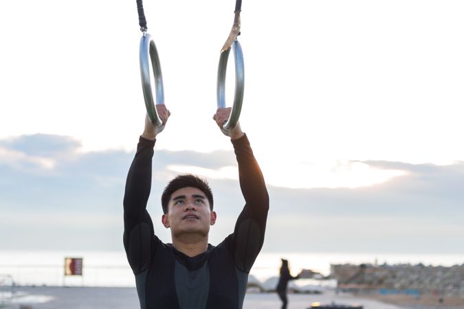Sportsman training on gymnastic rings