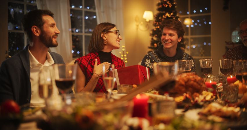 Family and Friends Gather at Home in the Evening for a Traditional Christmas Dinner with a Turkey Roast Feast