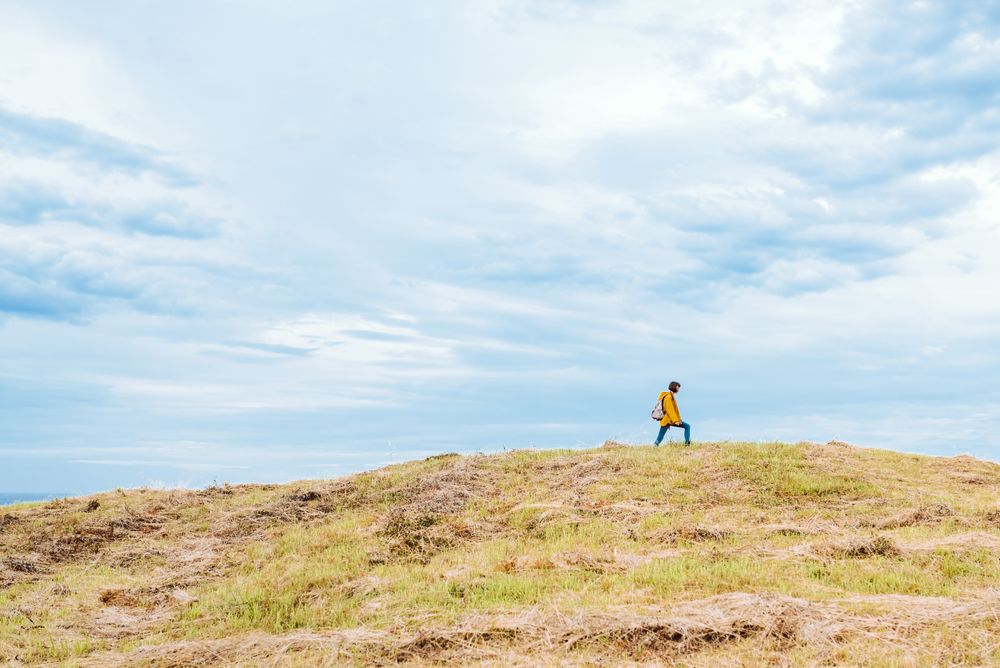 Female traveler on hill