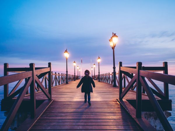 back view of anonymous girl on pier