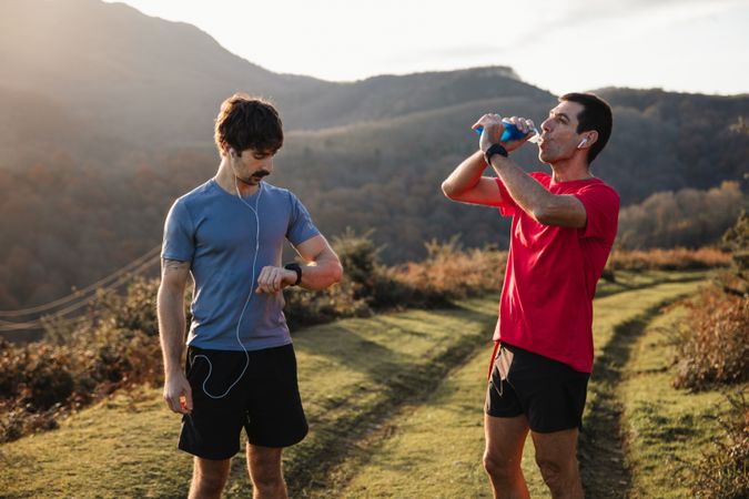 Sportive males taking break after running in mountains