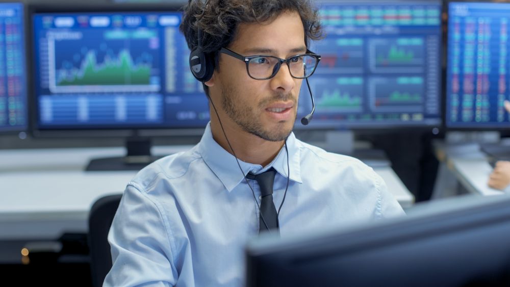 Customer Support Service Representative Talks with a Client Through Headset.