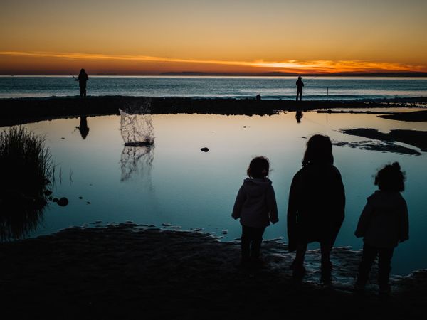 back view of little girls looking at sea