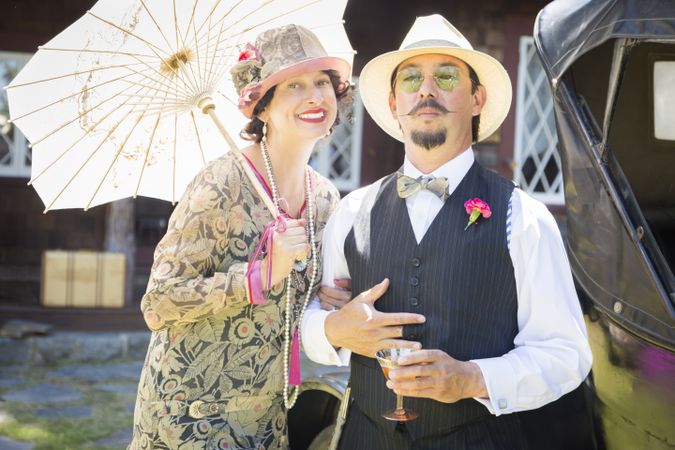 Couple Dressed in 1920’s Era Fashion Sipping Champagne