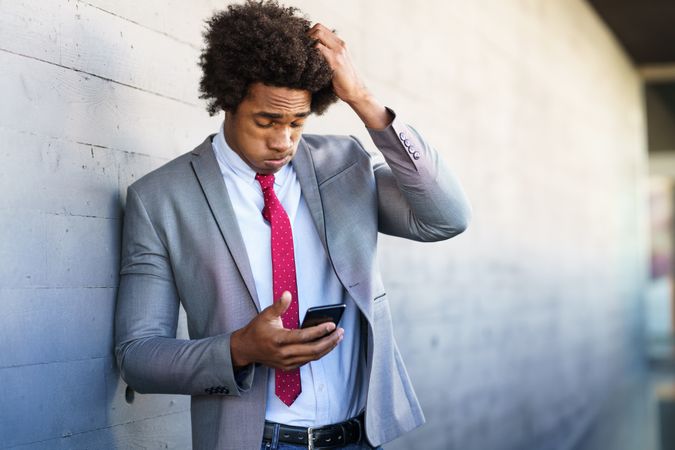 Stressed man checking his smart phone