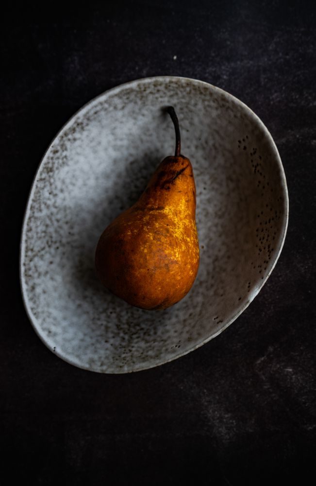 Sweet organic pear fruit in grey bowl
