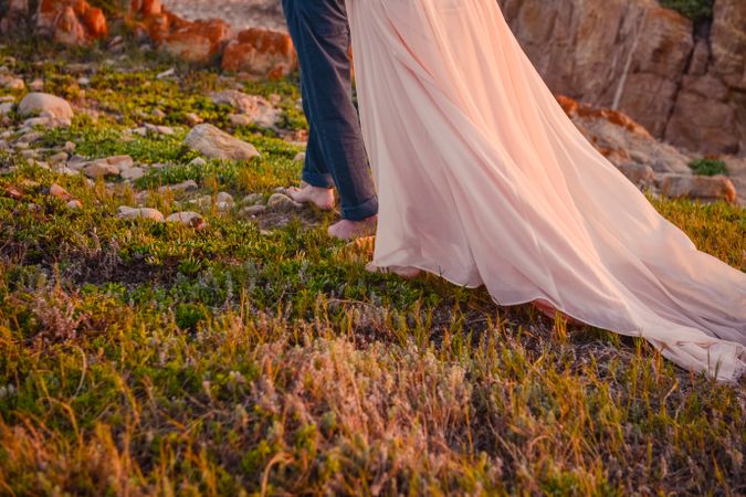 Man and woman in long dress walking in nature
