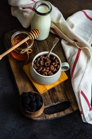 Sweet breakfast with chocolate cereal in mug with spoon