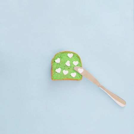 Tosted bread in vibrant green color with hearts on it