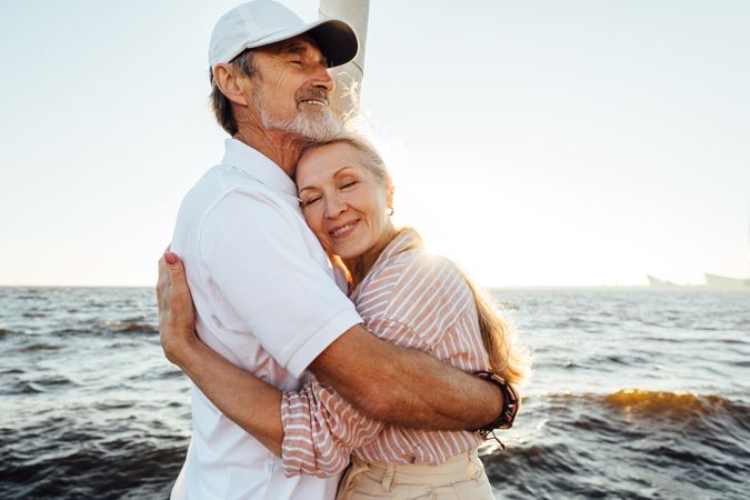Romantic couple enjoying sunset on the water