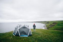 Man standing next to tent