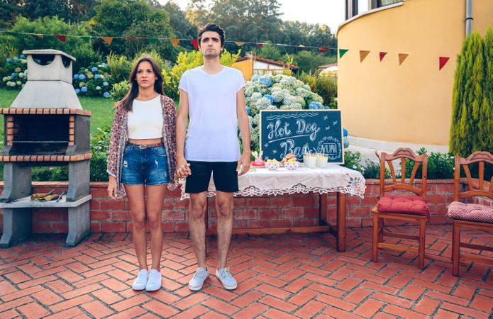 Couple standing in a outdoors summer barbecue