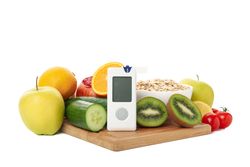 Blood glucose meter and diet food isolated on blank background