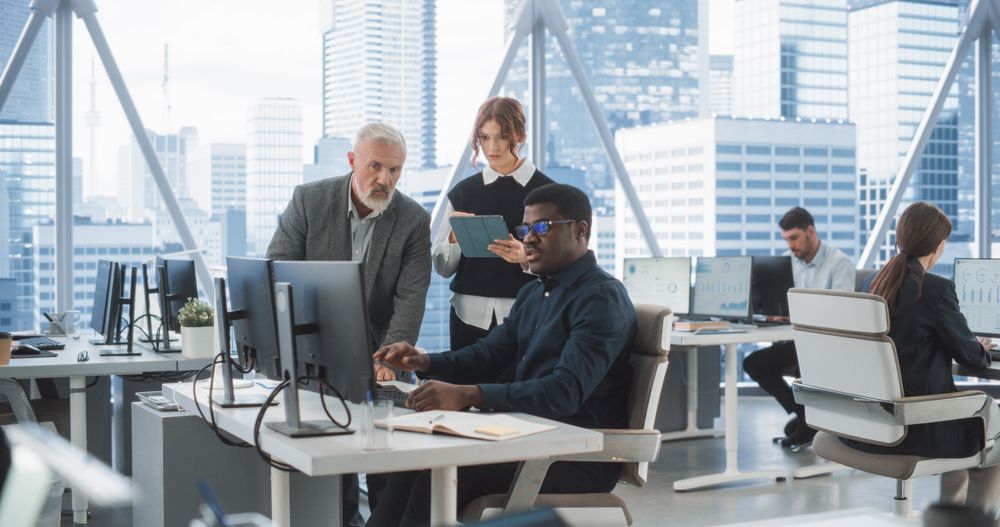 Black Male Developer Showing New Code To CEO And His Female Assistant With Tablet.