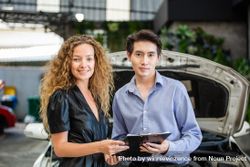 Asian car salesman with female client 5XeOv4