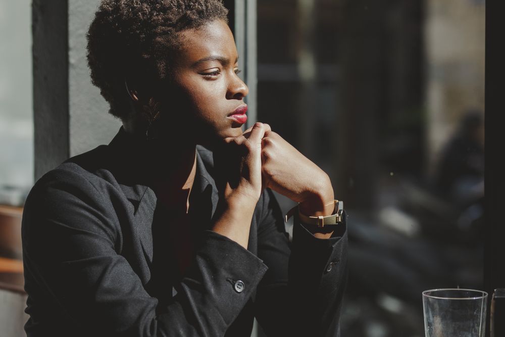 Smiling stylish Black woman in cafe
