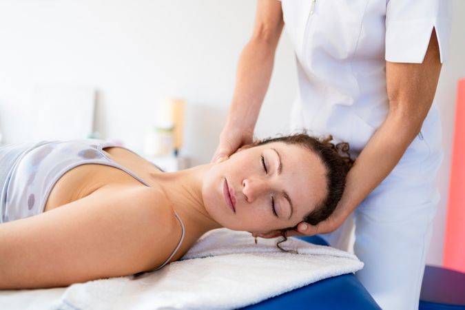 Relaxed woman getting physiotherapy treatment for neck
