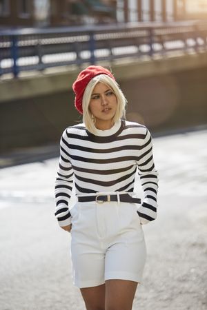 female in red beret outdoors