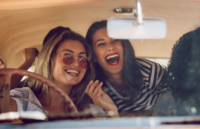 Young female friends going on vacation in a car