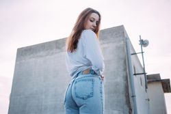 Red haired woman with her back to the camera on roof
