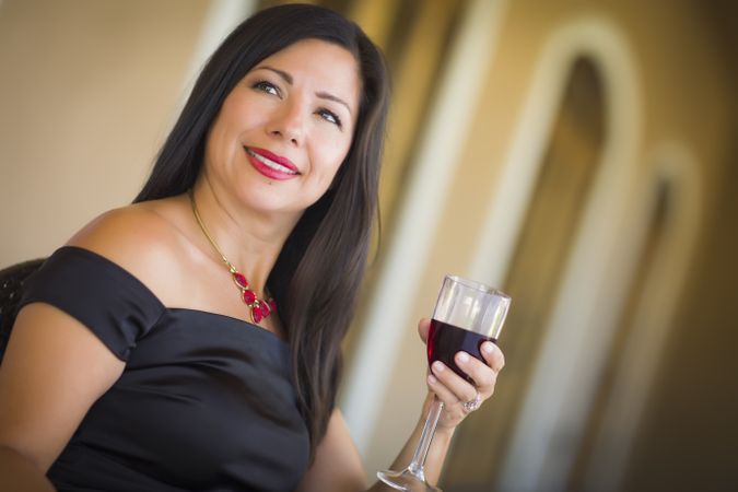Hispanic Woman Portrait Outside Enjoying Wine