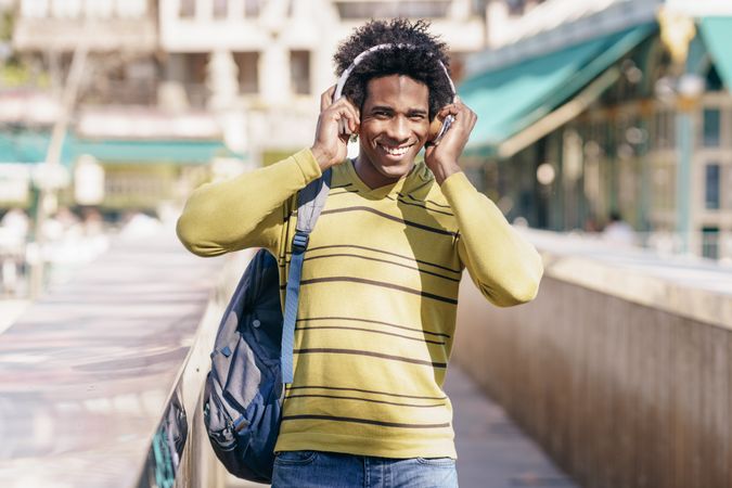 Man walking in Grenada Spain smiling with headphones