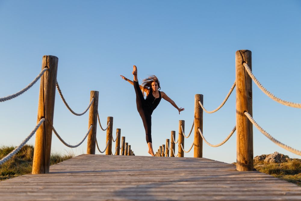Woman posing in air on footbridge