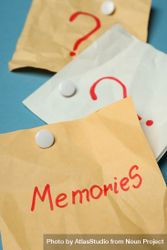 Pinned post it notes with the word “memories” on blue board, vertical 4dNYr0