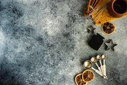 Christmas cookie baking equipment on stone background with copy space