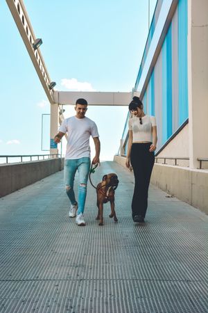 Couple with their Boxer dog.