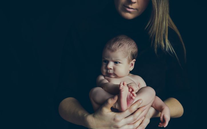 Baby posing in her mother's arms