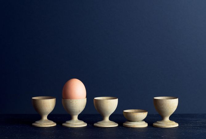 Egg cups and a single brown egg
