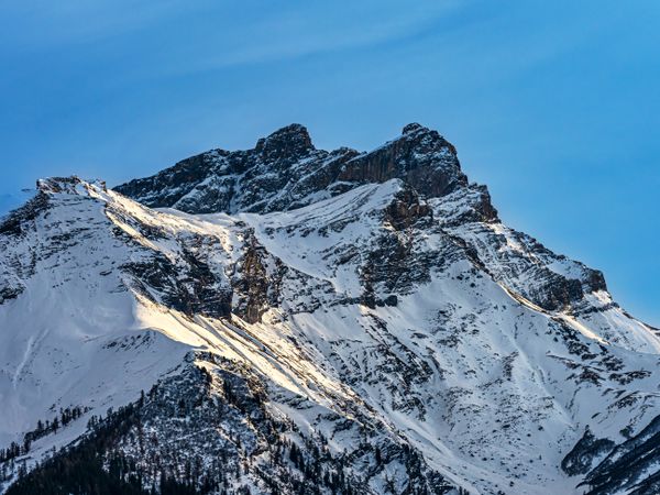 Swiss Alps winter landscape with snow and sun, mountains in Europe