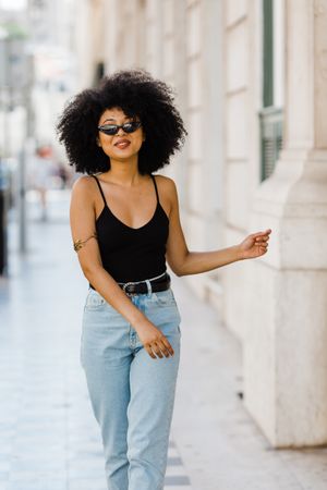 Cheerful Black female in dark sunglasses