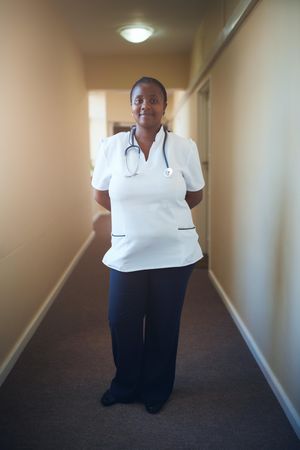 Caring female nurse looking at camera and smiling