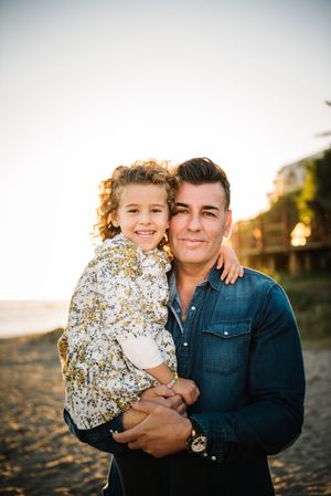 Father with her daughter at beach