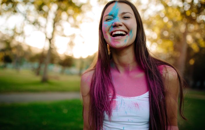 Beautiful woman with colored powder smeared on her face