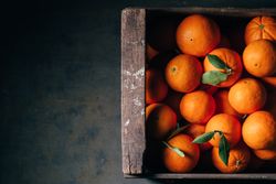 Fresh oranges in an old wooden box
