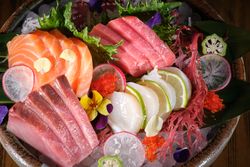 Sashimi dish served with fish and vegetables