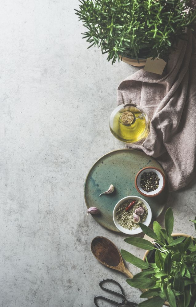Kitchen background with various flavor ingredients and seasoning on grey concrete kitchen table