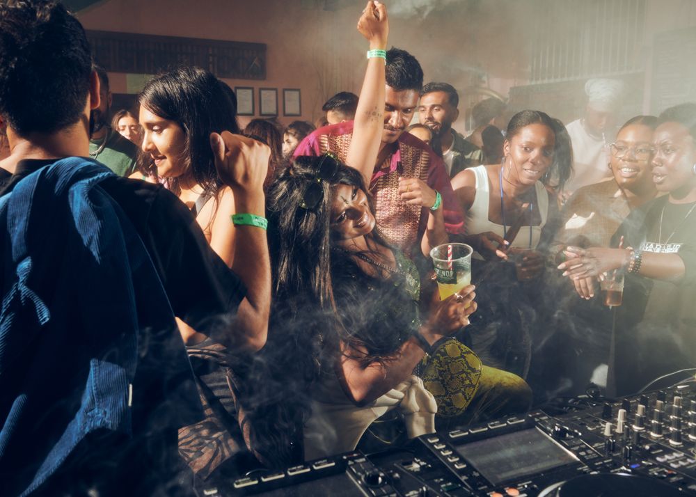 London, England, United Kingdom - Nov 9, 2022: Shot of people dancing at event in front of DJ