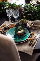 Spring table setting with teal bowl of decorative eggs