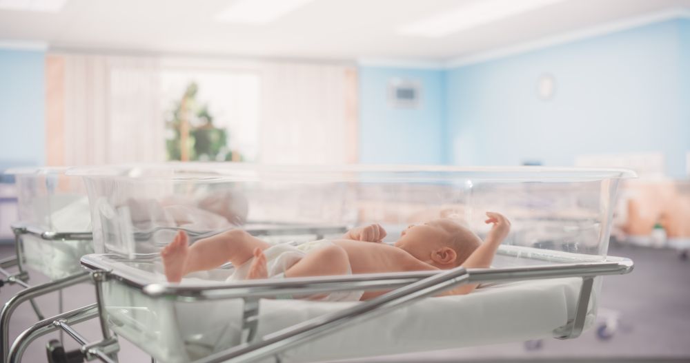 Adorable Newborn Child Lying in Hospital Bed in a Nursery Clinic.
