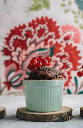Chocolate cakes in the cup with currants and sugar glass.